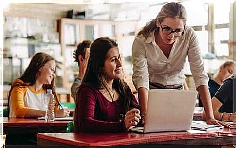 A teacher helping a student