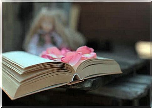 An open poetry book with flowers