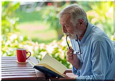 An elderly man reading.