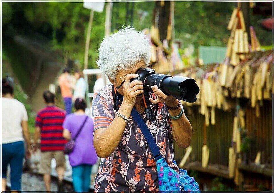 elderly woman taking pictures