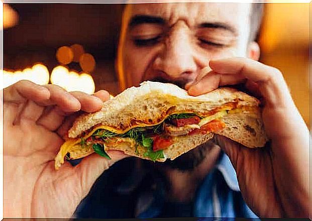 A man eating a sandwich. 