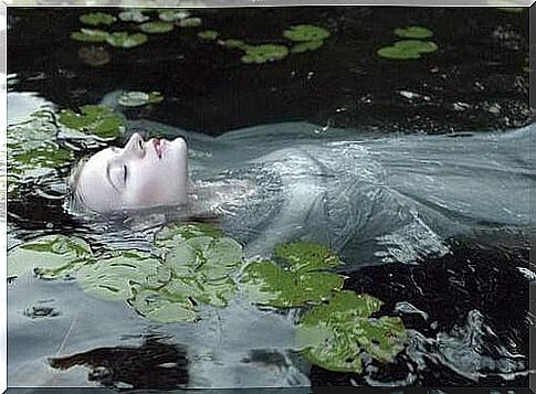 Woman-in-a-river-with-water lilies